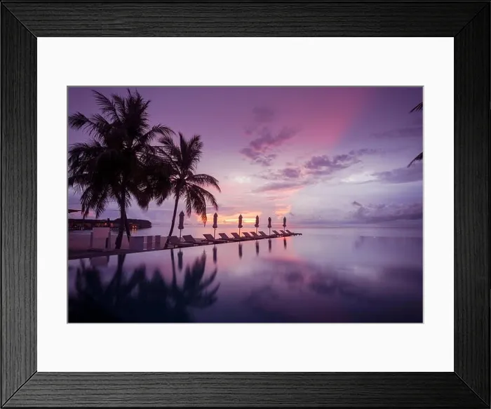Framed Print : Beautiful poolside and sunset sky with palm trees. Luxury tropical beach landscape, infinity swimming pool, deck chairs and loungers under umbrella Framed Print : Beautiful poolside and sunset sky with palm trees. Luxury tropical beach landscape, infinity swimming pool, deck chairs and loungers under umbrella