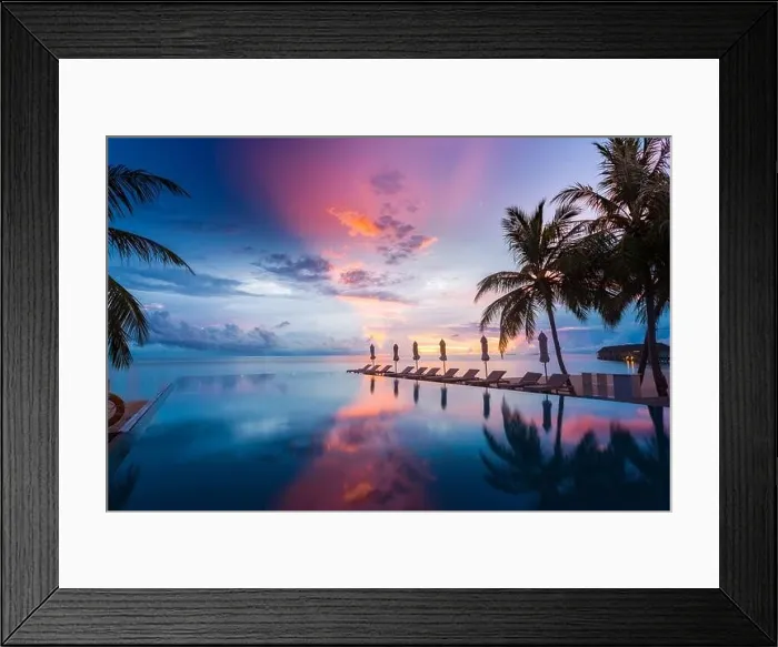 Framed Print : Beautiful poolside and sunset sky with palm trees. Luxury tropical beach landscape, infinity swimming pool, deck chairs and loungers under umbrella Framed Print : Beautiful poolside and sunset sky with palm trees. Luxury tropical beach landscape, infinity swimming pool, deck chairs and loungers under umbrella