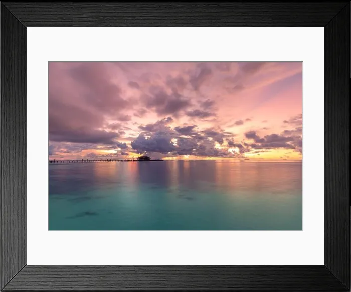 Framed Print : Maldives resort island in sunset with wooden jetty, amazing colorful sky. Perfect sunset beach scenery. Detail of clouds on colorful sky. Vacation Framed Print : Maldives resort island in sunset with wooden jetty, amazing colorful sky. Perfect sunset beach scenery. Detail of clouds on colorful sky. Vacation