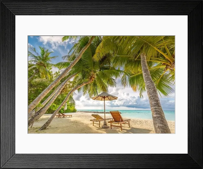 Framed Print : Beautiful beach tropical landscape, two sun beds, loungers, umbrella under palm tree. White sand, sea view with horizon, colorful twilight sky Framed Print : Beautiful beach tropical landscape, two sun beds, loungers, umbrella under palm tree. White sand, sea view with horizon, colorful twilight sky