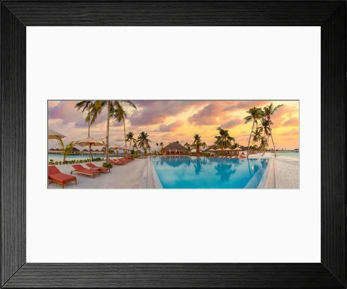 Framed Print : Fantastic panoramic poolside, sunset sky, palm trees. Luxury tropical beach landscape, infinity swimming pool, deck chairs beds under umbrellas