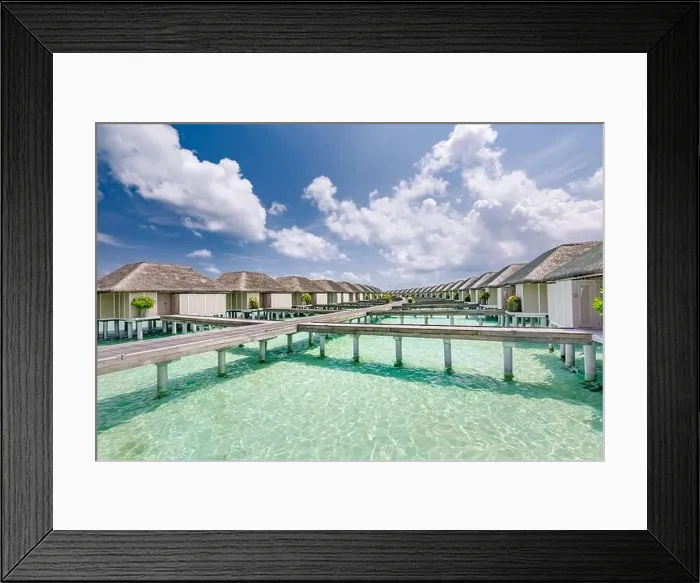 Framed Print : Tropical paradise: view of over water bungalows at a resort in the Maldives, Indian Ocean. Paradise beach. Holiday vacations tourism concept Framed Print : Tropical paradise: view of over water bungalows at a resort in the Maldives, Indian Ocean. Paradise beach. Holiday vacations tourism concept