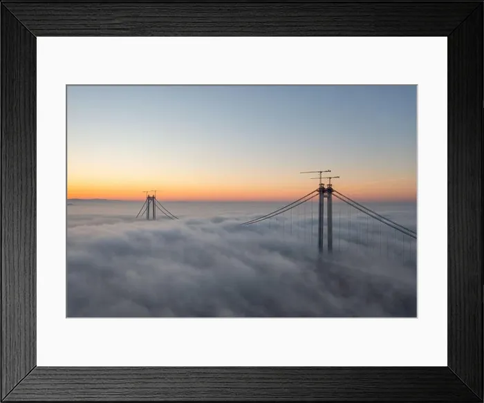 Framed Print : Panoramic aerial drone view from above of the suspended bridge over danube river, under construction, between Braila and Tulcea cities in Romania Framed Print : Panoramic aerial drone view from above of the suspended bridge over danube river, under construction, between Braila and Tulcea cities in Romania