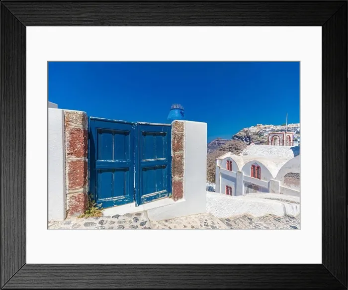 Framed Print : Fantastic travel background, Santorini urban landscape. Blue door or gate with stairs and white architecture under blue sky. Idyllic summer vacation Framed Print : Fantastic travel background, Santorini urban landscape. Blue door or gate with stairs and white architecture under blue sky. Idyllic summer vacation