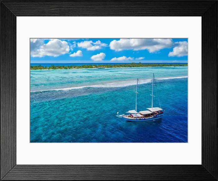 Framed Print : Small yacht sailing tropical sea over coral reef in Indian ocean lagoon. Exotic island landscape aerial view, stunning nature scenic freedom adventure Framed Print : Small yacht sailing tropical sea over coral reef in Indian ocean lagoon. Exotic island landscape aerial view, stunning nature scenic freedom adventure