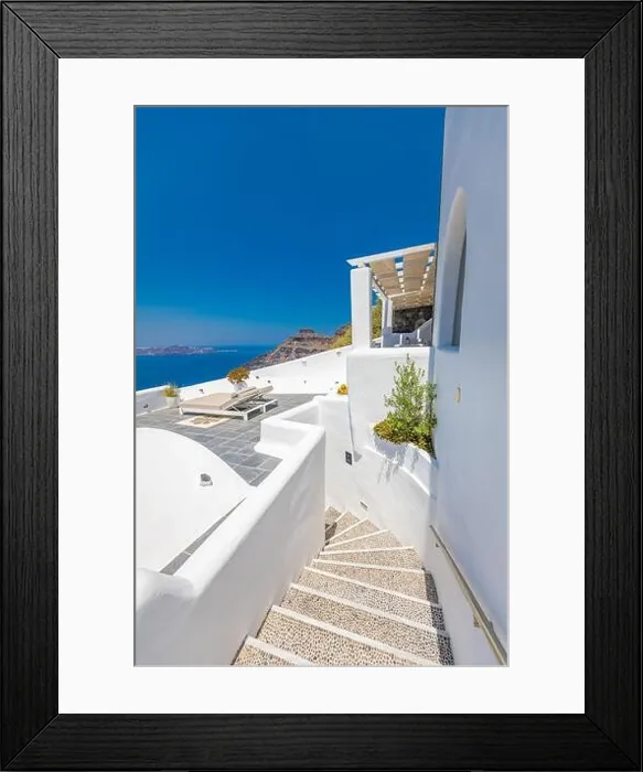 Framed Print : White wash staircases on Santorini Island, Greece. Caldera sea view, vertical travel panorama. Blue sunny sky Framed Print : White wash staircases on Santorini Island, Greece. Caldera sea view, vertical travel panorama. Blue sunny sky
