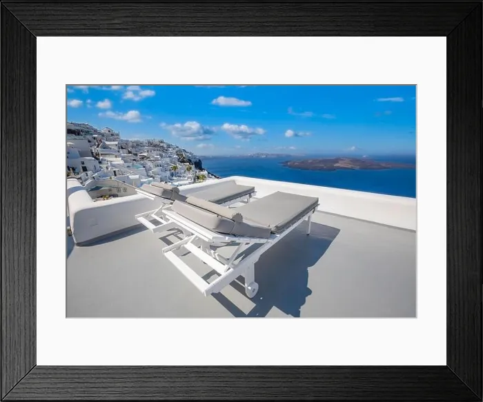 Framed Print : Amazing destination scenic. Two chairs umbrella on caldera terrace in Santorini, Greece. White famous architecture, blue sea sky view. Honeymoon Framed Print : Amazing destination scenic. Two chairs umbrella on caldera terrace in Santorini, Greece. White famous architecture, blue sea sky view. Honeymoon