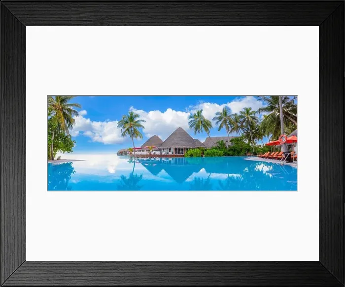 Framed Print : Outdoor tourism landscape. Luxurious beach resort with swimming pool and beach chairs or loungers under umbrellas with palm trees and blue sky. Summer Framed Print : Outdoor tourism landscape. Luxurious beach resort with swimming pool and beach chairs or loungers under umbrellas with palm trees and blue sky. Summer