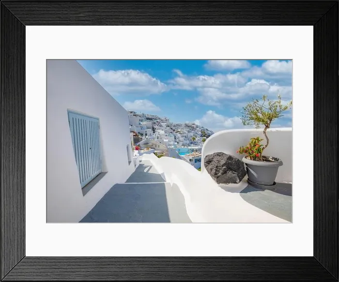Framed Print : Greek island of Santorini. Amazing travel panorama, white houses, stairs and flowers on the streets. Idyllic summer vacation, urban landscape, tourism