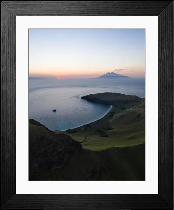 Framed Print : Seen from a bird's eye view, an idyllic, tropical island, Gili Banta, is lit by the setting sun just outside of Komodo National Park, Indonesia Framed Print : Seen from a bird's eye view, an idyllic, tropical island, Gili Banta, is lit by the setting sun just outside of Komodo National Park, Indonesia