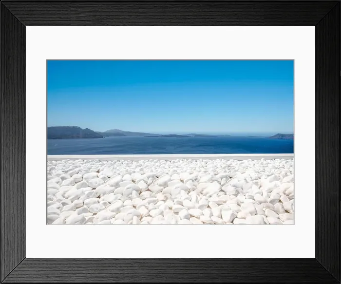 Framed Print : Traditional white architecture on Santorini island, Greece. White pebbles over blue sea view, idyllic calming travel landscape. Beautiful white decor Framed Print : Traditional white architecture on Santorini island, Greece. White pebbles over blue sea view, idyllic calming travel landscape. Beautiful white decor