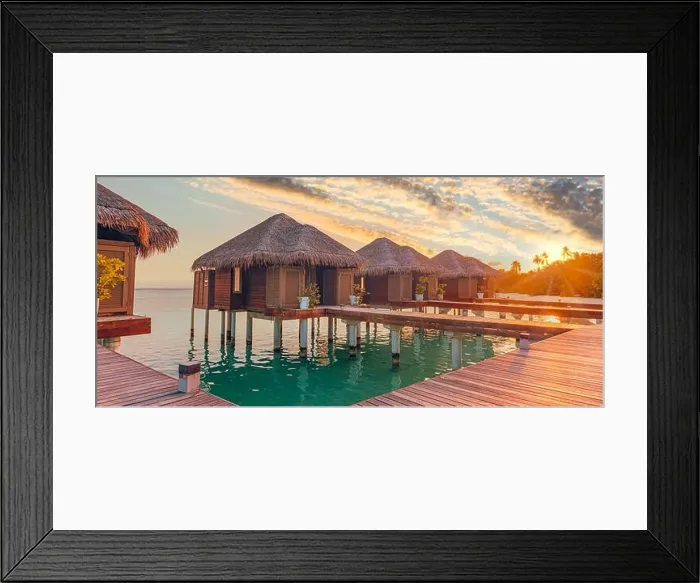 Framed Print : Sunset on Maldives island, luxury water villas resort hotel and wooden pier. Colorful sky and clouds and beach background for summer vacation holiday Framed Print : Sunset on Maldives island, luxury water villas resort hotel and wooden pier. Colorful sky and clouds and beach background for summer vacation holiday