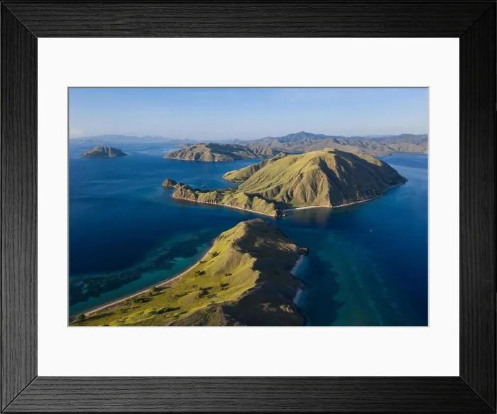Framed Print : Seen from an aerial view, afternoon light shines on rugged islands in Komodo National Park, Indonesia. This area has high marine biodiversity