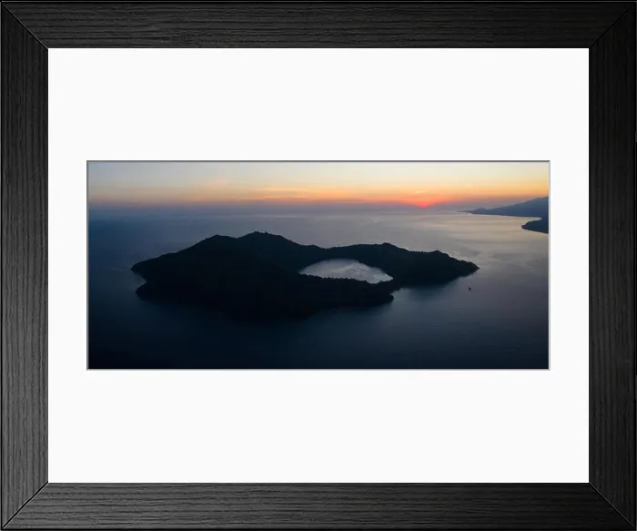 Framed Print : Seen from a bird's eye view, the blue Pacific Ocean surrounds the scenic volcano of Satonda, just north of Sumbawa in Indonesia Framed Print : Seen from a bird's eye view, the blue Pacific Ocean surrounds the scenic volcano of Satonda, just north of Sumbawa in Indonesia