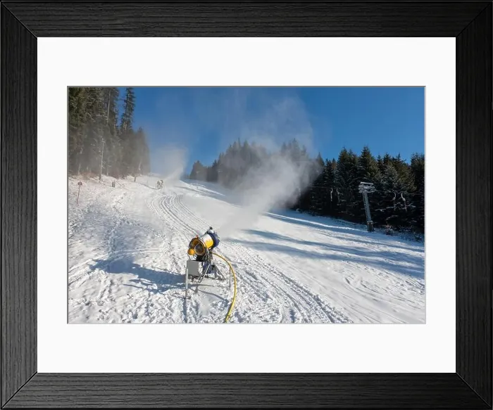 Framed Print : Snow cannon in winter mountains slope. Snow-gun spraying artificial ice crystals. Machine making snow Framed Print : Snow cannon in winter mountains slope. Snow-gun spraying artificial ice crystals. Machine making snow