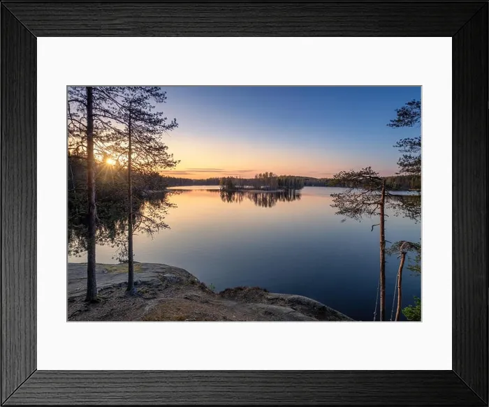 Framed Print : Scenic landscape with sunset, peaceful lake and tree roots at calm spring evening in Finland Framed Print : Scenic landscape with sunset, peaceful lake and tree roots at calm spring evening in Finland