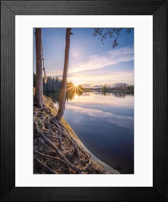 Framed Print : Scenic landscape with sunset, peaceful lake and tree roots at calm spring evening in Finland Framed Print : Scenic landscape with sunset, peaceful lake and tree roots at calm spring evening in Finland