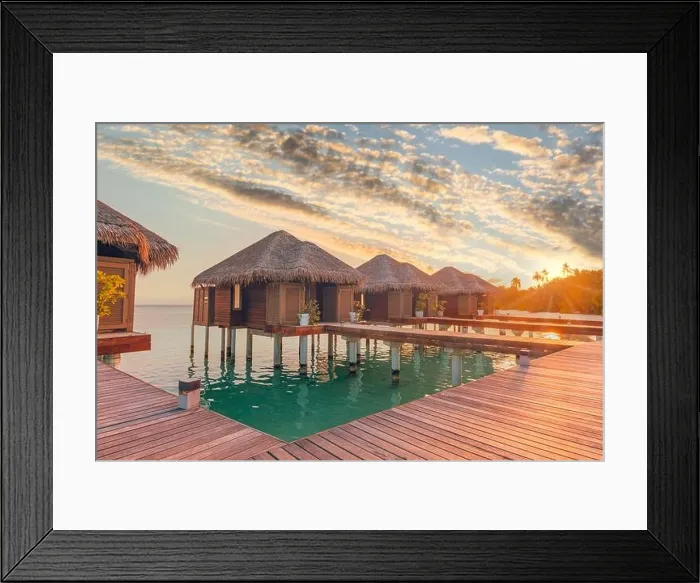 Framed Print : Sunset on Maldives island, luxury water villas resort hotel and wooden pier. Colorful sky and clouds and beach background for summer vacation holiday Framed Print : Sunset on Maldives island, luxury water villas resort hotel and wooden pier. Colorful sky and clouds and beach background for summer vacation holiday
