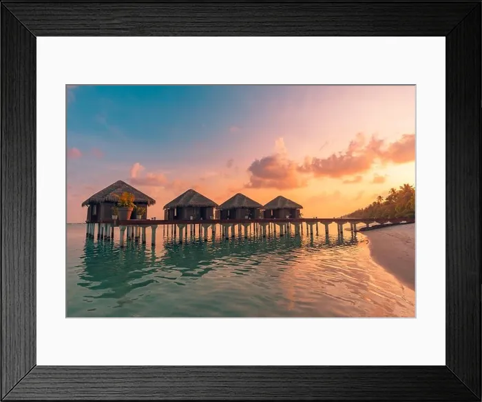 Framed Print : Sunset on Maldives island, luxury water villas resort hotel and wooden pier. Colorful sky and clouds and beach background for summer vacation holiday Framed Print : Sunset on Maldives island, luxury water villas resort hotel and wooden pier. Colorful sky and clouds and beach background for summer vacation holiday