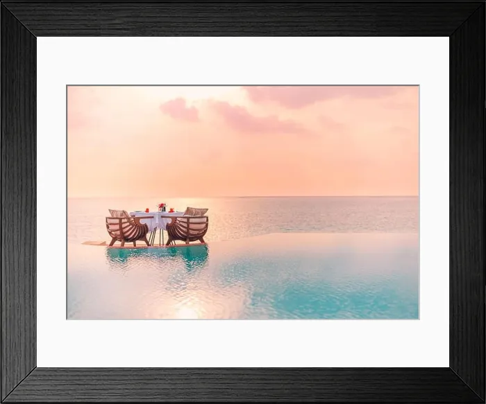 Framed Print : Summer love and romance table setup for a romantic dinner meal with luxury infinity pool reflection chairs under sunset sky and sea in background Framed Print : Summer love and romance table setup for a romantic dinner meal with luxury infinity pool reflection chairs under sunset sky and sea in background