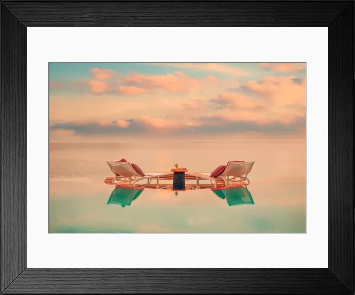 Framed Print : Summer love and romance table setup for a romantic dinner meal with luxury infinity pool reflection chairs under sunset sky and sea in background Framed Print : Summer love and romance table setup for a romantic dinner meal with luxury infinity pool reflection chairs under sunset sky and sea in background