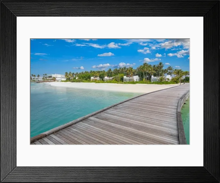 Framed Print : Beautiful tropical Maldives resort hotel and island shore with beach and sea sky for holiday vacation background concept. Jetty into island paradise Framed Print : Beautiful tropical Maldives resort hotel and island shore with beach and sea sky for holiday vacation background concept. Jetty into island paradise