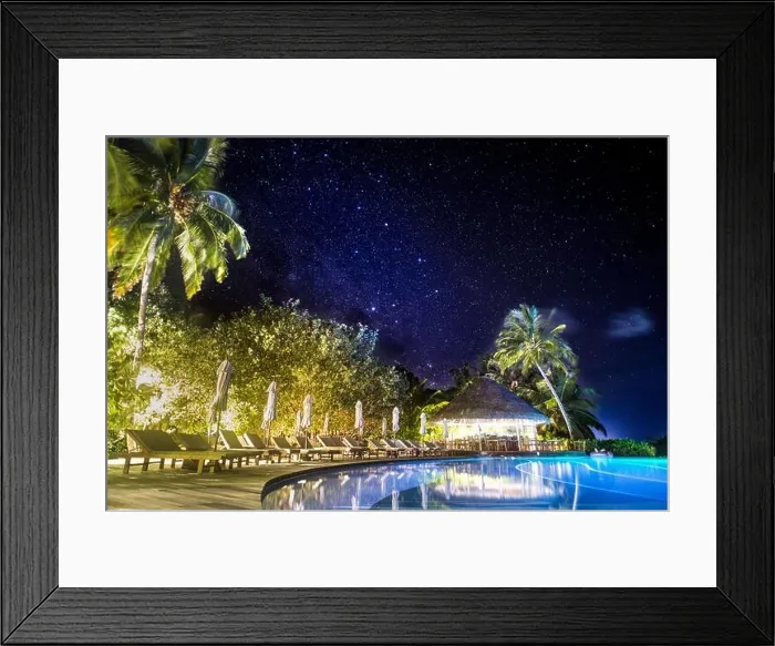 Framed Print : Swimming pool in night illumination under milky way, stars. Palm trees and closed umbrellas with palm trees over infinity swimming pool Framed Print : Swimming pool in night illumination under milky way, stars. Palm trees and closed umbrellas with palm trees over infinity swimming pool