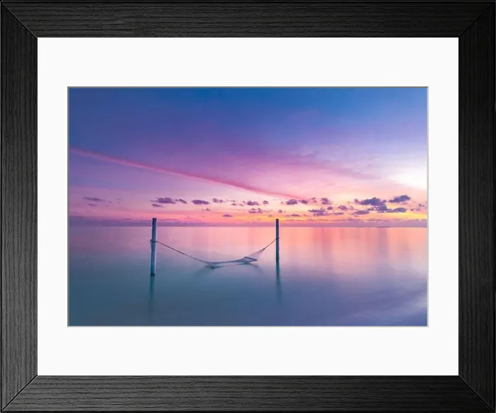 Framed Print : Seascape view of sunset over Maldives lagoon with empty hammock hanged over water. Sunset sea, luxury summer travel vacation scenery. Exotic beach Framed Print : Seascape view of sunset over Maldives lagoon with empty hammock hanged over water. Sunset sea, luxury summer travel vacation scenery. Exotic beach
