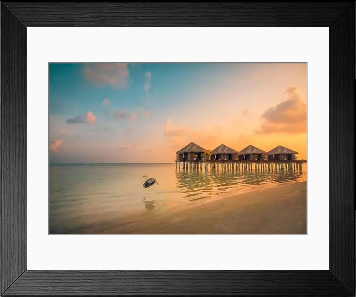 Framed Print : Sunset on Maldives island, luxury water villas resort and wooden pier. Beautiful sky clouds and beach background for summer vacation holiday travel Framed Print : Sunset on Maldives island, luxury water villas resort and wooden pier. Beautiful sky clouds and beach background for summer vacation holiday travel