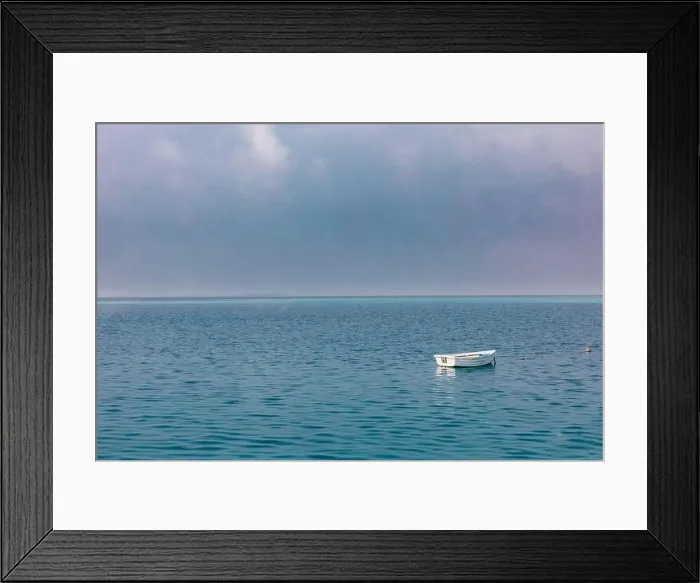 Framed Print : Old rowing boat marooned at sea. Lonely wooden boat, cloudy sky, calm ocean ripples with horizon Framed Print : Old rowing boat marooned at sea. Lonely wooden boat, cloudy sky, calm ocean ripples with horizon
