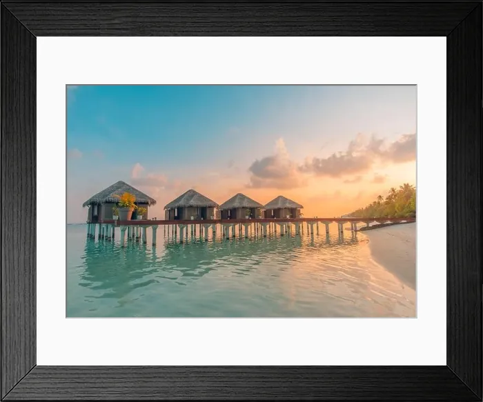 Framed Print : Sunset on Maldives island, luxury water villas resort and wooden pier. Beautiful sky clouds and beach background for summer vacation holiday travel Framed Print : Sunset on Maldives island, luxury water villas resort and wooden pier. Beautiful sky clouds and beach background for summer vacation holiday travel