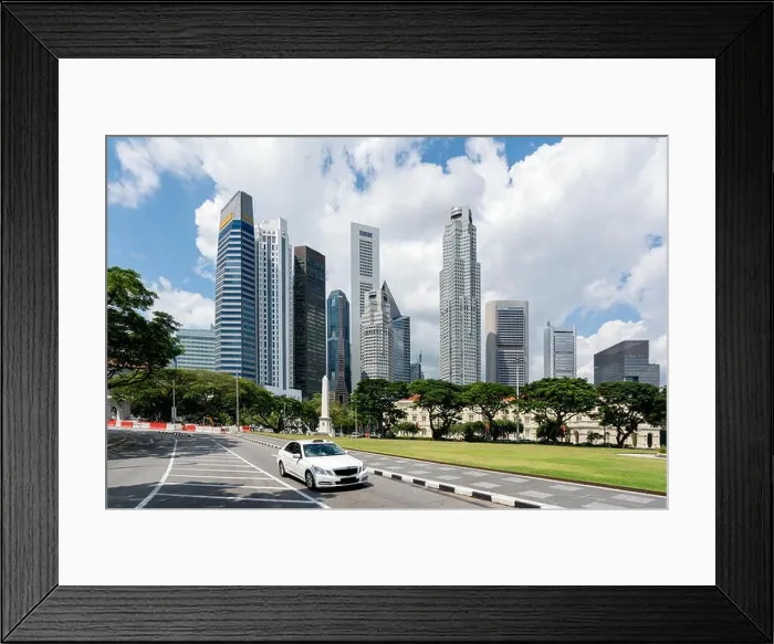 Framed Print : Taxi cab driving in road in Singapore downtown with Singapore skyscrapers building in background. Asia Framed Print : Taxi cab driving in road in Singapore downtown with Singapore skyscrapers building in background. Asia