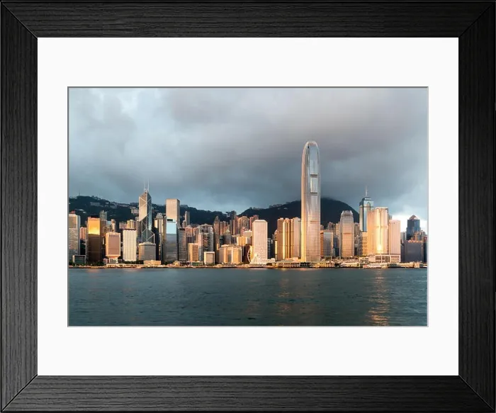 Framed Print : Hong Kong skyline with sunlight in the morning over Victoria Harbour in Hong Kong Framed Print : Hong Kong skyline with sunlight in the morning over Victoria Harbour in Hong Kong