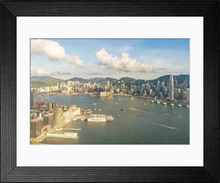 Framed Print : Aerial view of Hong Kong skyline and Victoria Harbor with blue sky in Hong Kong. Asia Framed Print : Aerial view of Hong Kong skyline and Victoria Harbor with blue sky in Hong Kong. Asia