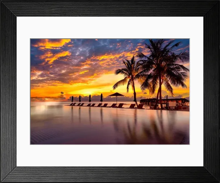 Framed Print : Sunrise blue and pink light scattering across the clouds and pool, reflecting the infinity pool and silhouetted palm trees. Luxury resort and travel Framed Print : Sunrise blue and pink light scattering across the clouds and pool, reflecting the infinity pool and silhouetted palm trees. Luxury resort and travel