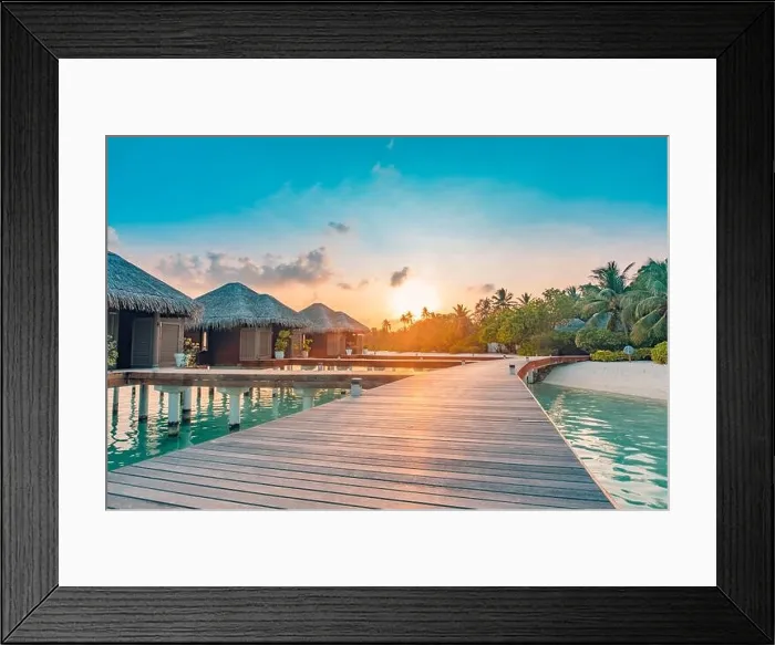 Framed Print : Sunset on Maldives island, luxury water villas resort and wooden pier. Beautiful sky clouds and beach background for summer vacation holiday travel Framed Print : Sunset on Maldives island, luxury water villas resort and wooden pier. Beautiful sky clouds and beach background for summer vacation holiday travel