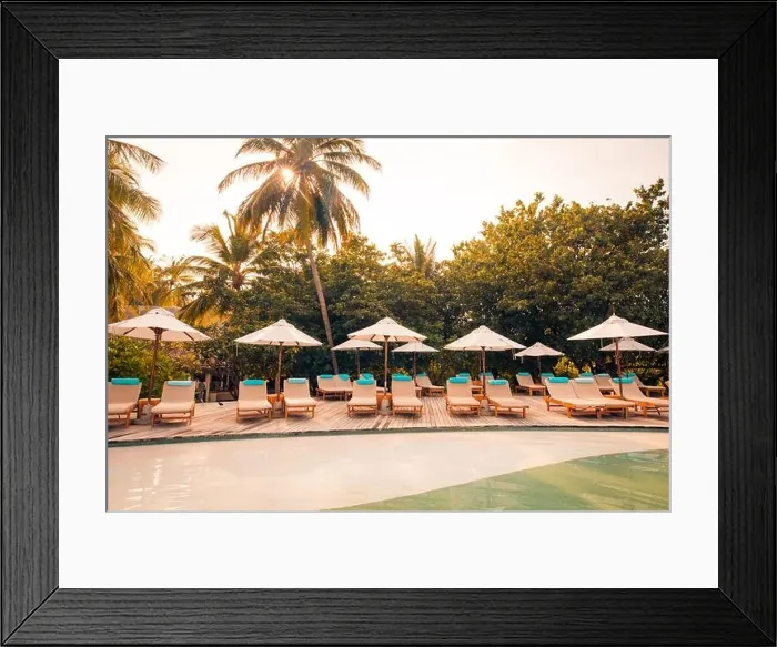 Framed Print : Beautiful tropical beach at resort hotel island. Poolside with chairs, lounger under umbrella and palm trees. Summer holiday, vacation travel concept Framed Print : Beautiful tropical beach at resort hotel island. Poolside with chairs, lounger under umbrella and palm trees. Summer holiday, vacation travel concept