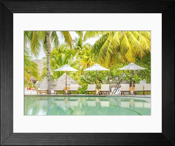 Framed Print : Beautiful tropical beach at resort hotel island. Poolside with chairs, lounger under umbrella and palm trees. Summer holiday, vacation travel concept Framed Print : Beautiful tropical beach at resort hotel island. Poolside with chairs, lounger under umbrella and palm trees. Summer holiday, vacation travel concept