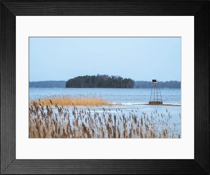 Framed Print : Sea landscape with mood cloudy day and life saving chair at winter afternoon in Finland Framed Print : Sea landscape with mood cloudy day and life saving chair at winter afternoon in Finland