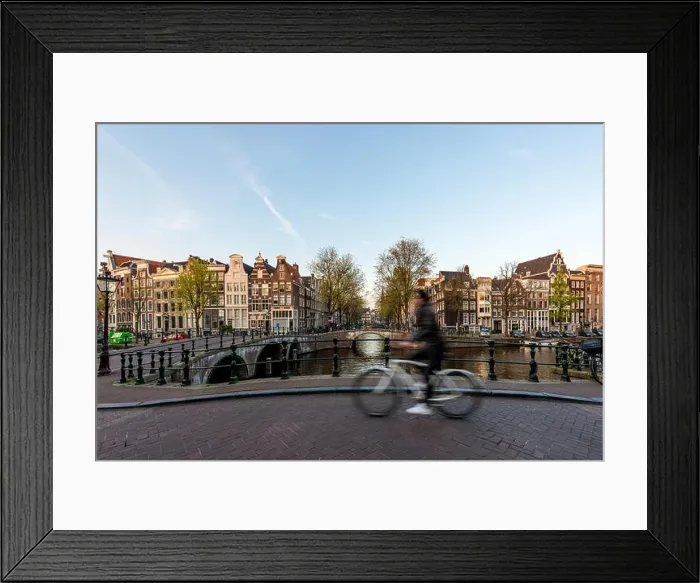 Framed Print : Amsterdam people riding bicycles in historical part in Amsterdam, Netherlands Framed Print : Amsterdam people riding bicycles in historical part in Amsterdam, Netherlands