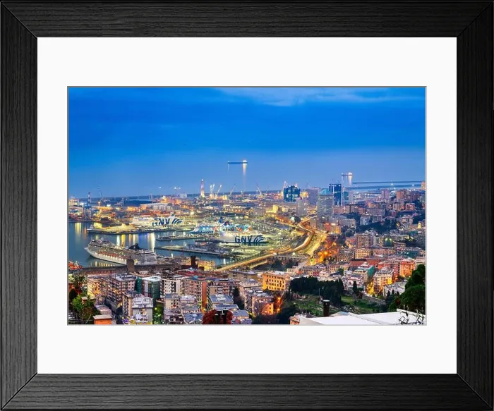 Framed Print : GENOA, ITALY - DECEMBER 31, 2021: Ferries and cargo ships wait in the Port of Genoa at dusk. With a trade volume of 51.6 million tonnes, it is one of Framed Print : GENOA, ITALY - DECEMBER 31, 2021: Ferries and cargo ships wait in the Port of Genoa at dusk. With a trade volume of 51.6 million tonnes, it is one of