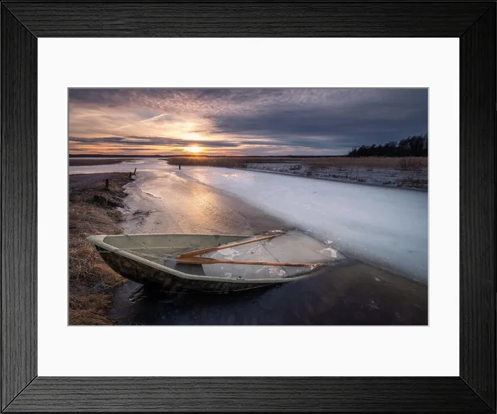 Framed Print : Scenic landscape with sunset and abandoned boat at spring evening in Finland. Boat is almoust in the ice Framed Print : Scenic landscape with sunset and abandoned boat at spring evening in Finland. Boat is almoust in the ice