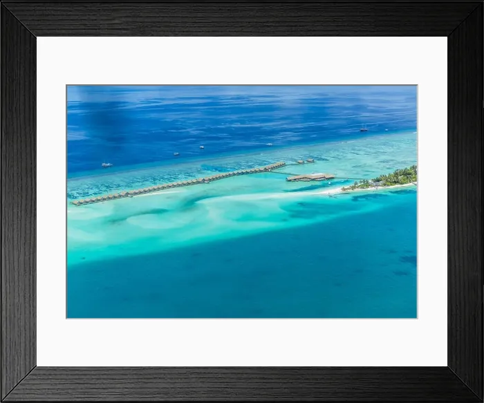 Framed Print : Aerial view of Maldives paradise beach. Luxury island resort Beautiful palm trees and tropical beach. Moody blue sky and blue lagoon Framed Print : Aerial view of Maldives paradise beach. Luxury island resort Beautiful palm trees and tropical beach. Moody blue sky and blue lagoon