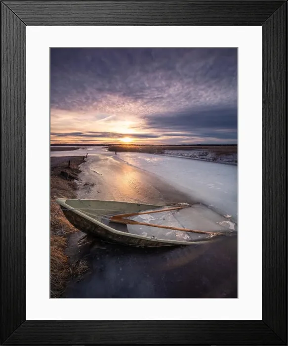 Framed Print : Scenic landscape with sunset and abandoned boat at spring evening in Finland. Boat is almoust in the ice Framed Print : Scenic landscape with sunset and abandoned boat at spring evening in Finland. Boat is almoust in the ice