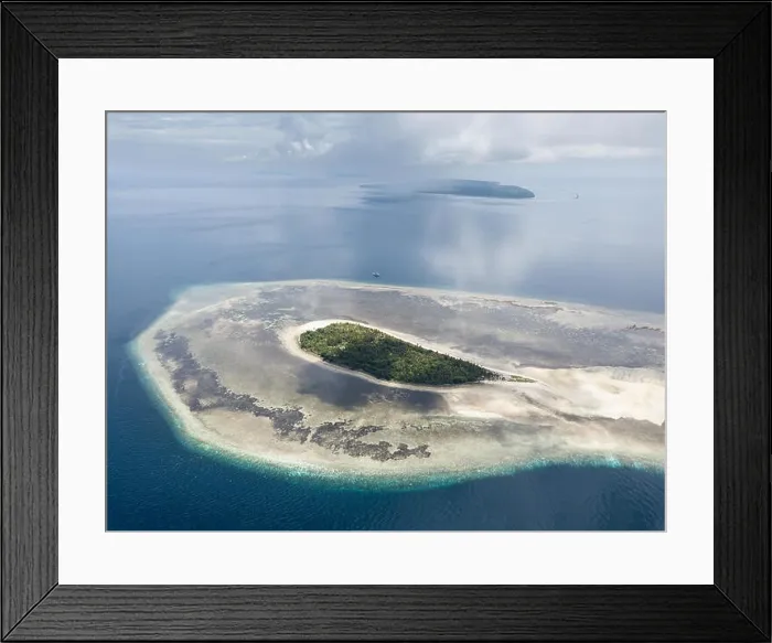Framed Print : A gorgeous coral reef surrounds the remote island of Koon in the Banda Sea of Indonesia. This tropical region is known for its marine biodiversity Framed Print : A gorgeous coral reef surrounds the remote island of Koon in the Banda Sea of Indonesia. This tropical region is known for its marine biodiversity