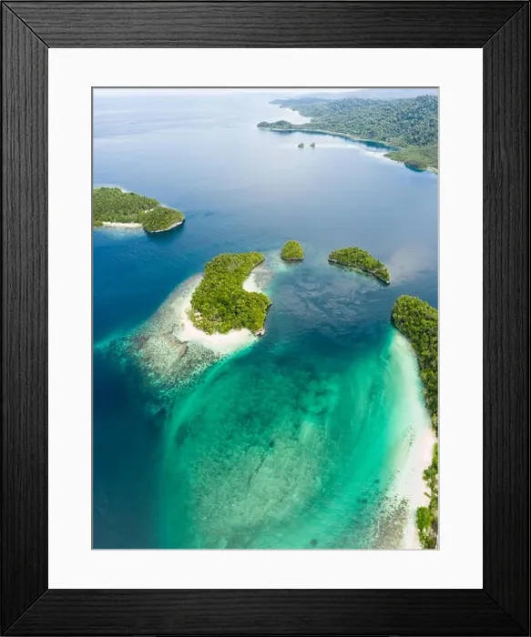 Framed Print : Limestone islands, surrounded by coral reefs, lie scattered throughout the Raja Ampat seascape. This region is known for its marine biodiversity Framed Print : Limestone islands, surrounded by coral reefs, lie scattered throughout the Raja Ampat seascape. This region is known for its marine biodiversity