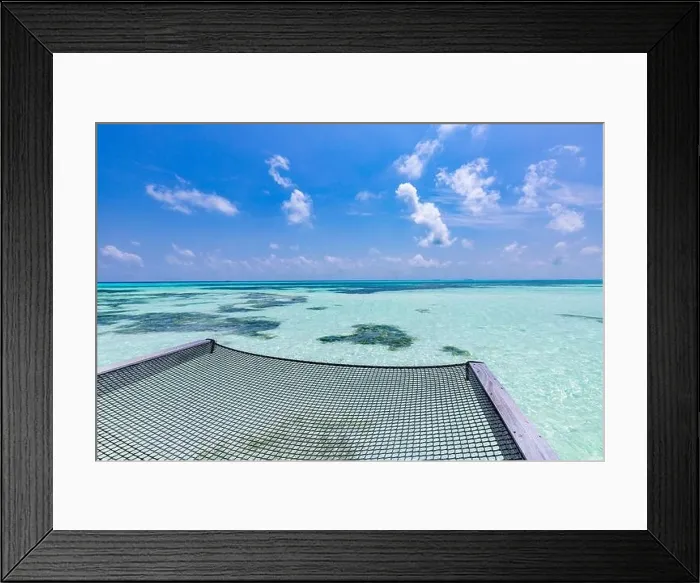 Framed Print : Empty over water hammock in the middle of tropical lagoon in Maldives. Luxury travel vacation concept. Seascape view from luxurious resort Framed Print : Empty over water hammock in the middle of tropical lagoon in Maldives. Luxury travel vacation concept. Seascape view from luxurious resort