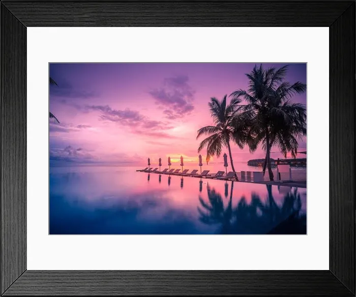 Framed Print : Beautiful poolside and sunset sky with palm trees. Luxury tropical beach landscape, infinity swimming pool, deck chairs and loungers under umbrella an Framed Print : Beautiful poolside and sunset sky with palm trees. Luxury tropical beach landscape, infinity swimming pool, deck chairs and loungers under umbrella an