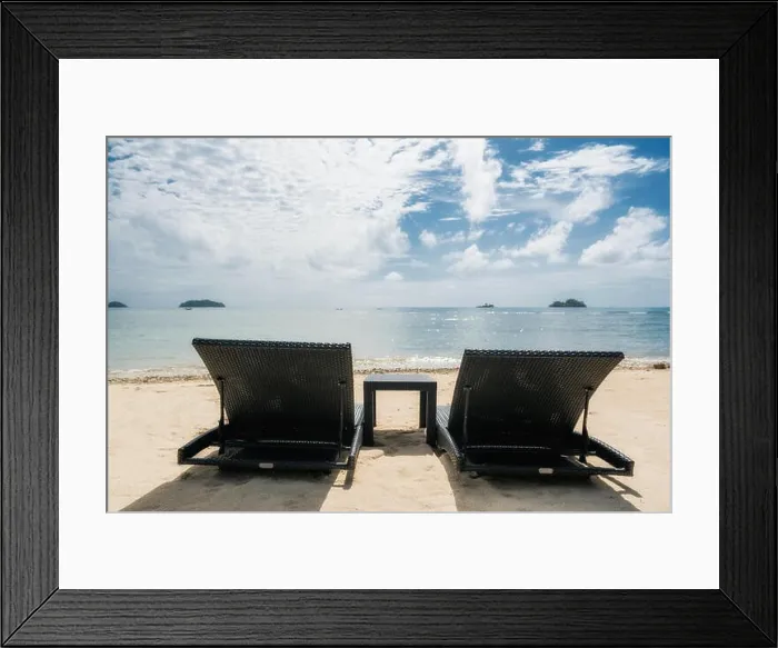 Framed Print : Beach chairs on the sandy beaches for tourists to sit and relax with soft ocean waves breaking on beach. Summer travel vacation and holiday concept Framed Print : Beach chairs on the sandy beaches for tourists to sit and relax with soft ocean waves breaking on beach. Summer travel vacation and holiday concept