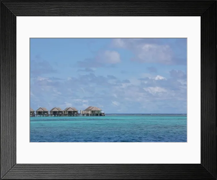 Framed Print : Maldives island, luxury water villas resort and wooden pier. Beautiful sky and clouds and beach background for summer vacation holiday and travel Framed Print : Maldives island, luxury water villas resort and wooden pier. Beautiful sky and clouds and beach background for summer vacation holiday and travel
